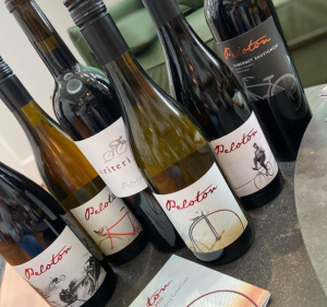 Peloton Cellars, a deep purple tasting room with white trim, its doors open to the bar inside